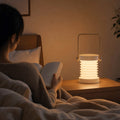 Reading in bed by the warm light of the Cream White lantern