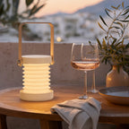 Cordless lantern on a terrace dinner table at dusk